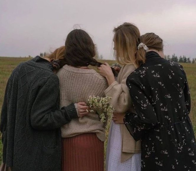 Friends embracing in a field, representing solidarity